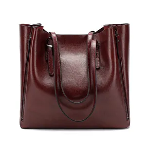 Detailed view of wine red oil leather tote bag, soft texture and dual shoulder handles.