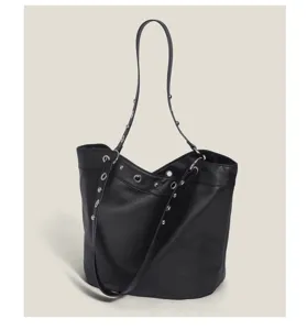 Close-up view of a black litchi pattern leather shoulder bucket bag with metal rivet details.