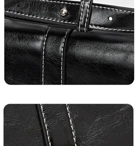 Black vintage saddle bag leather detail, fine stitching texture and metal button buckle.