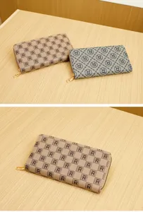 Close-up detail of stylish monogram printed long zip wallet, premium clutch purse for women.