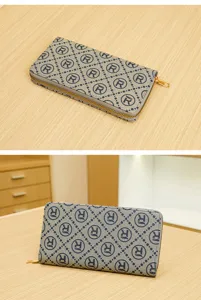Detailed view of the stylish zipper wallet with geometric monogram pattern and gold hardware.