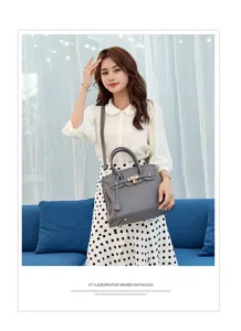 Classic pebbled leather tote bag with metal turn lock, stylish shoulder handbag for women.