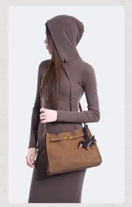 Vintage brown suede shoulder bag for women with chic lock belt and cute dachshund charm.