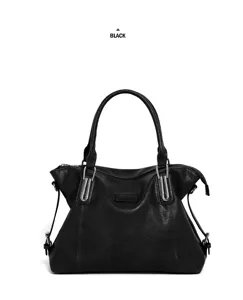 Detail shot of black leather tote bag showing metal hardware and handle details.