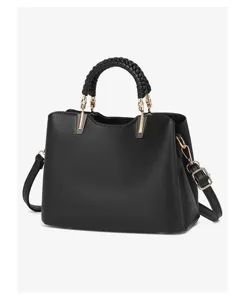 Detailed view of black PU leather handbag with elegant braided top handle and gold hardware.