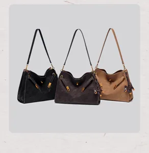 Retro suede shoulder bag for women, vintage crossbody tote with lock and belt decor.