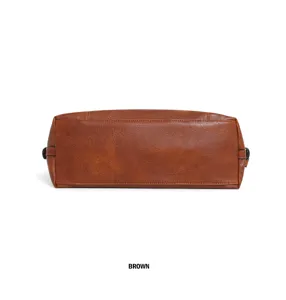 Detailed view of the bottom of a brown faux leather vintage tote handbag, showing clean stitching.