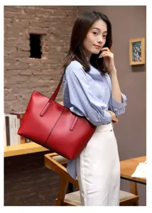 Red leather tote bag for women, casual large capacity shoulder bag for commuting and travel.