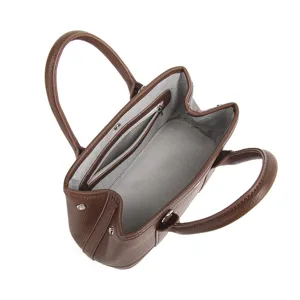 Brown leather tote bag for women with double handles and structured central zip compartment.