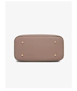 Handbag bottom detail view featuring durable taupe leather and four gold metal protective feet.