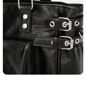 Black PU leather tote bag detail view, featuring stylish metal buckles and rivets design.