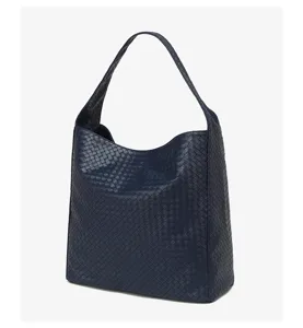 Close-up of the navy blue woven leather texture, highlighting the exquisite craftsmanship.