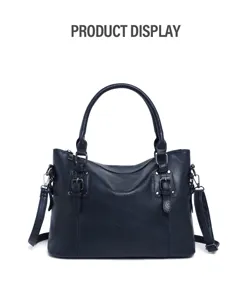 Detailed view of dark blue leather handbag hardware and texture, large capacity design.