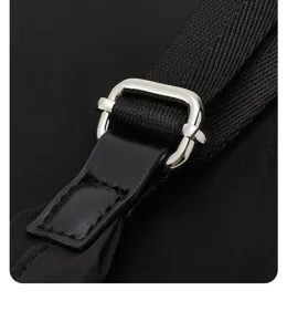 Close up detail view of the black oxford backpack adjustable metal buckle and strap hardware.