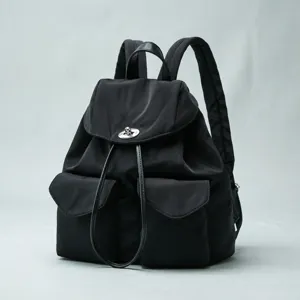 Black nylon backpack with metal orb clasp, casual travel daypack and stylish school bag.