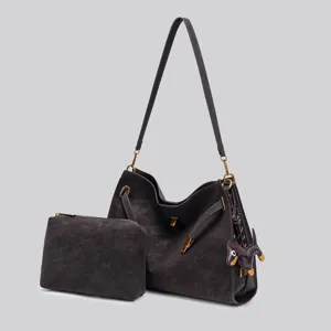Dark brown vintage suede shoulder bag set with lock closure and matching pouch for women.