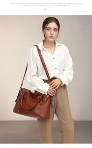 Detailed view of retro brown leather shoulder bag worn by model in studio setting.