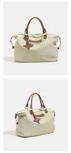Large capacity casual travel handbag with brown leather trim, dual top handles, side strap rings.