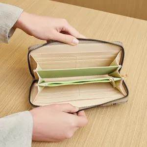 Women's long zip-around clutch wallet with card slots and zipper pocket for daily commute.