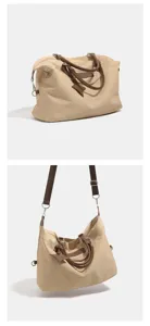 Detailed view of large capacity casual travel tote bag with brown leather handles and strap.