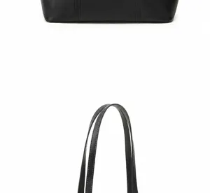 Vista detallada del asa y fondo del bolso tote de cuero negro, diseño de estilo urbano minimalista.