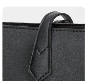 Primer plano de la correa del bolso de cuero negro, costuras finas y textura elegante.