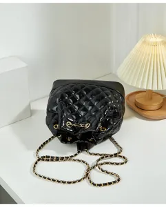 Black quilted leather bucket bag with gold chain strap, stylish casual shoulder bag