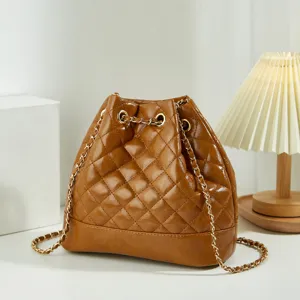 Classic brown quilted bucket bag with elegant chain strap for women, stylish and chic.