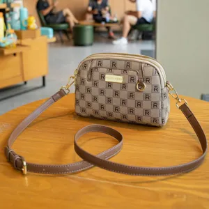 Classic brown monogram shell crossbody bag with adjustable strap and metal hardware.