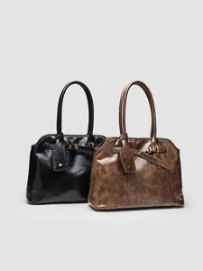Retro briefcase style detail shot showing black and brown large capacity shell handbags.