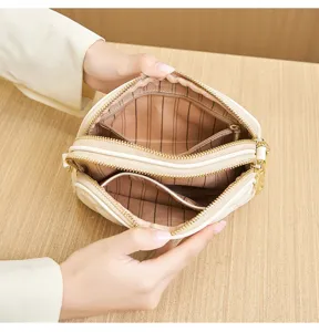 Small quilted multi-compartment casual handbag detail showing interior zip pocket design.