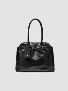 Black leather handbag detail, showing elegant shoulder strap and stylish metal hardware accents.
