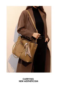 Elegant brown tote bag with stylish checkered scarf accessory detail shot for modern women.