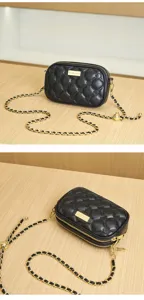 Black quilted leather detail view showcasing the elegant gold chain strap and metal plate.
