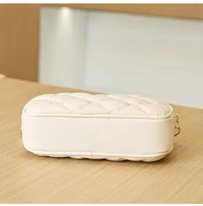 Beige quilted small square bag with elegant embossed pattern, stylish and versatile.