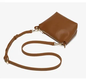 Brown leather shoulder bag with gold-tone hardware and secure zipper closure for daily commute.