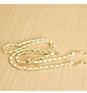 Gold and white leather intertwined chain strap detailed view with metal clasps for shoulder bag.