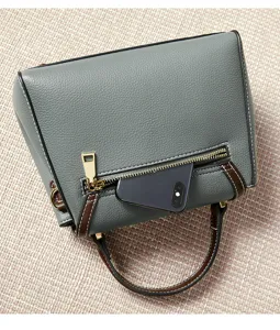 Grey leather shoulder handbag with brown trim, zipper pocket detail, and gold hardware.