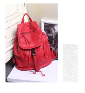 Red soft leather backpack for women, stylish travel shoulder bag and casual college bookbag.