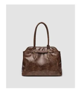 Detail view of vintage brown PU leather handbag with metallic buckle and dual handles.