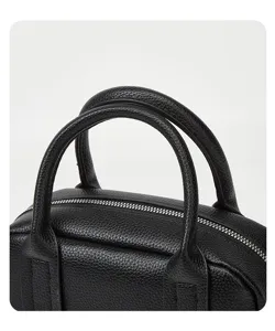Black leather Boston bag handle detail, premium texture handbag, elegant daily crossbody use.