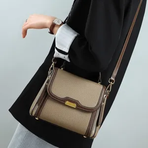 Detailed view of the elegant women's leather shoulder bag with chic hardware and straps.