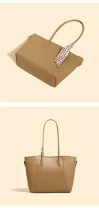Khaki leather tote bag handle detail showing stylish checkered ribbon decoration and clean stitching.