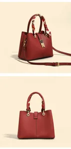 Red leather handbag detail showing chic scarf handle and elegant gold-tone metal clasp.