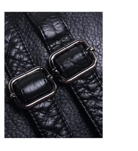 Black soft leather backpack close-up detail showing durable metal buckle and textured strap.