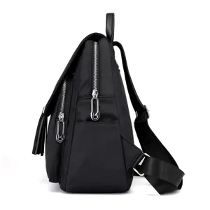 Black oxford cloth fashion backpack side view with tassel and silver zippers for travel daily use