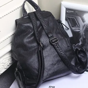 Black soft leather backpack for women, casual travel daypack with adjustable straps.