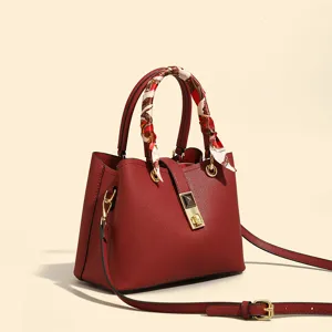 Elegant red leather tote bag with silk scarf handle, premium crossbody shoulder bag for women.