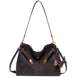 Vintage suede shoulder bag for women, retro brown handbag with lock and cute dog charm.