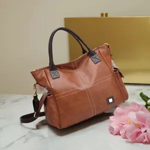 Detailed view of the vintage brown PU leather tote bag with elegant contrast stitching.